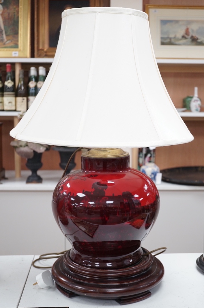A large Royal Doulton flambe vase, approximately 30.5 cm high excluding all later fittings, mounted as a lamp with shade and associate wood stand.